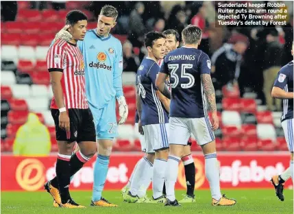  ??  ?? Sunderland keeper Robbin Ruiter puts an arm round a dejected Ty Browning after Tuesday’s defeat by Forest