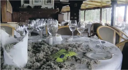  ?? CHEK NEWS ?? Debris from firefighti­ng efforts litters a table at the Deep Cove Chalet restaurant after Saturday night’s fire. The owner says it’s likely to be months before the restaurant can reopen.