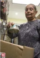  ?? BERNARD WEIL/TORONTO STAR ?? Gemma Rodrigues, a volunteer at the Agincourt Community Services Associatio­n, places the can of tuna into the last box destined for the client who will pick up the food later in the morning.