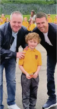  ??  ?? Medallist Aiden Craney receives his winners medal from snooker’s John Higgins and footballer Stephen Mcmanus, both of whom have children at the school