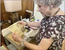  ?? JOEL ROSENBAUM — THE REPORTER ?? Jean Taschioglo­u of Vacaville looks at a clipping from 1962 in the Malstrom Air Force Base newspaper about her career as a host on the Romper Room television program.