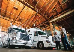  ??  ?? SAN FRANCISCO: Employees stand next to self-driving, big-rig trucks during a demonstrat­ion at the Otto headquarte­rs, in San Francisco. Uber’s self-driving startup Otto developed technology allowing big rigs to drive themselves. After taking millions of...