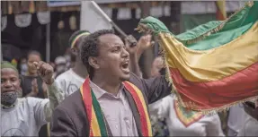  ?? Photo: Nampa/AFP ?? A supporter of the Ethiopian Citizen for Social Justice (EZEMA) opposition party reacts while holding the national flag during the closing event of their electoral campaign in Addis Ababa on 13 June 2021. Ethiopia is preparing to hold crucial and twice-delayed elections across the country on 21 June despite growing concern over the credibilit­y of the vote as well as a famine in war-torn Tigray.