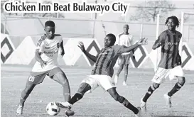  ??  ?? Bulawayo City defender Lewis Ncube (left) tries to make his way past Chicken Inn’s Ishmael Lawe while Michael Bhebhe (right) monitors the action during a Heroes Day match at White City Stadium in Bulawayo yesterday