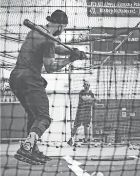  ?? ERICA CALHOUN/BISHOP MCNAMARA HIGH SCHOOL ?? Coach Anthony Sosnoskie throws indoor batting practice to senior Josh Wilson.