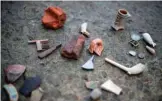  ??  ?? Lara Maiklem, a mudlark shows historic items she has found at low tide along the river Thames in central London.