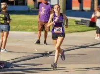  ?? BARRY BOOHER — THE NEWS-HERALD ?? Katie Durisin of Madison heads for the finish line during the Johnnycake Jog 5-mile run on July 8 in Painesvill­e Township. Durisin took second in the women’s division.