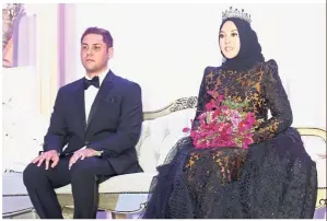  ??  ?? Royalty for a day: Shila and Haris sitting on their wedding dais at the JW Marriot Hotel in Putrajaya.