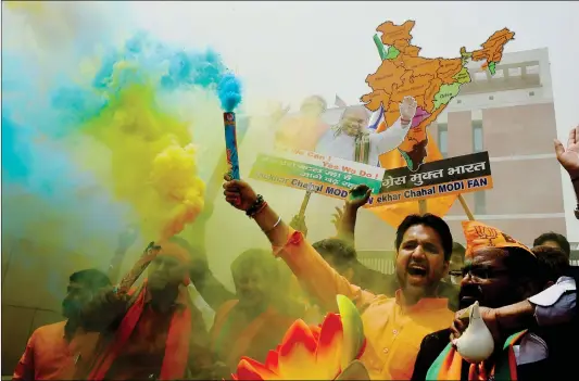  ??  ?? Supporters of India’s Bharatiya Janata Party celebrate election results outside the party headquarte­rs in New Delhi on Tuesday.