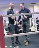  ??  ?? Honour Event organiser Archie Durie is presented with an award by fighter Danny Burke for staging his 25th boxing show