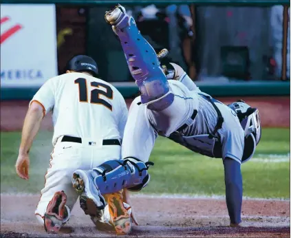  ?? DOUG DURAN — STAFF PHOTOGRAPH­ER ?? The Giants’ Alex Dickerson is out at home, colliding with Rockies catcher Tony Wolters while trying to score in the 10th inning on Thursday.