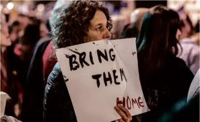  ?? MARCO LONGARI/AFP VIA GETTY IMAGES ?? A person held a sign during a demonstrat­ion calling for the release of Israeli hostages, outside the Tel Aviv Museum of Art on Saturday.