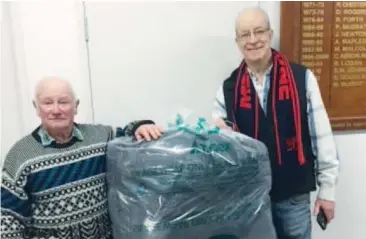  ??  ?? Members of Poowong and District Landcare Jeff Clarke and Mark Walters depicting Plasbac bag for silage wrap disposal.