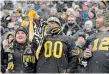  ?? THE HAMILTON SPECTATOR ?? Tiger-Cats fans whoop it up in the stands during the semifinal match against Montreal. Tickets for Sunday’s Grey Cup are sold out.