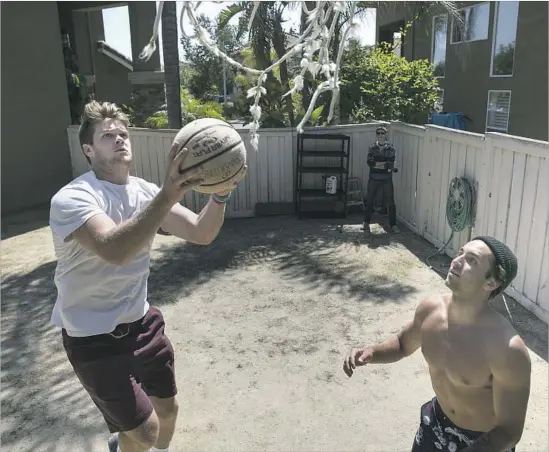  ?? Robert Gauthier Los Angeles Times ?? DARNOLD PLAYS BASKETBALL with longtime friend Dean Licht, right, in Licht’s backyard. With his new fame, Darnold appreciate­s time with his friends more.