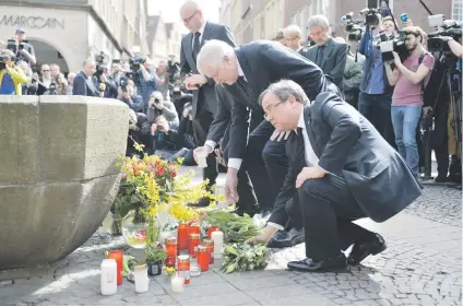  ?? Picture: AFP ?? HEARTFELT TRIBUTE. German interior minister Horst Seehofer, second right, and state leader in North Rhine-Westphalia Armin Laschet lay flowers in the Münster city square.