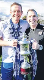  ??  ?? Montrose manager Stewart Petrie and captain Paul Watson with the League Two trophy.