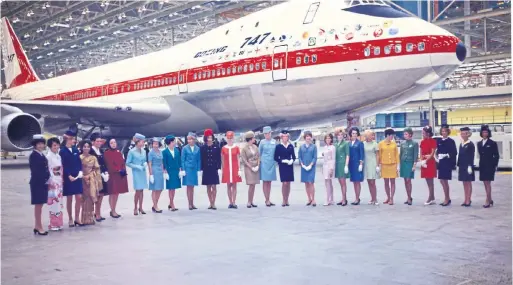  ?? JED GOODE ?? A prototype for the Boeing 747, at the time the time the world’s biggest plane, is rolled out in 1968 in Everett, Wash., with flight attendants from global airlines.