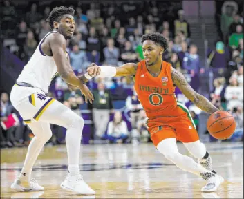  ?? The Associated Press file ?? Chris Lykes, right, formerly of Miami, ranked among the Atlantic Coast Conference’s top 10 scorers each of the previous two seasons. He will play for Arkansas this year.