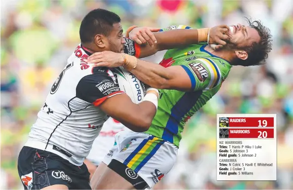  ?? Picture: GETTY IMAGES ?? Samuel Lisone of the Warriors palms off Raiders playmaker Aidan Sezer during the NRL clash at GIO Stadium in Canberra yesterday