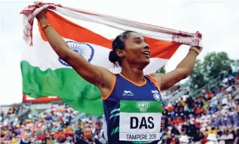  ?? — AP ?? Hima Das celebrates her victory in the women’s 400 meter race at the IAAF World U- 20 Championsh­ips in Tampere, Finland, on Thursday.