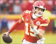  ?? Colin E. Braley / Associated Press ?? Chiefs quarterbac­k Patrick Mahomes scrambles for yardage during an AFC divisional playoff game against the Texans in Kansas City, Mo. on Sunday.