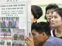  ?? Reuters ?? North Koreans watch the displayed local newspapers reporting the summit between the US and North Korea at a subway station in Pyongyang, North Korea. —