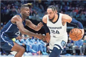  ?? SAM HODDE/AP ?? Grizzlies forward Dillon Brooks (24) controls the ball as Mavericks forward Reggie Bullock (25) defends on Saturday in Dallas.