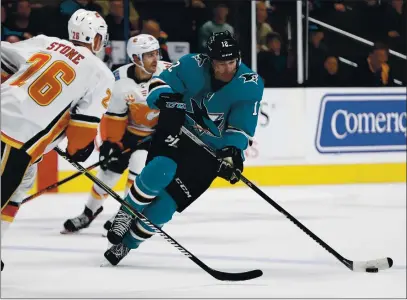  ?? NHAT V. MEYER — BAY AREA NEWS GROUP, FILE ?? The Sharks’ Patrick Marleau controls the puck against Flames’ Michael Stone (26) in the third period at SAP Center in San Jose on Feb. 10.