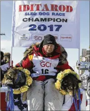  ?? DIANA HAECKER / AP ?? Last year’s Iditarod champion Mitch Seavey poses with his dogs. His son, Dallas, was involved in a doping scandal after the race. Four of Dallas’ dogs tested positive for tramadol, an opioid pain reliever.