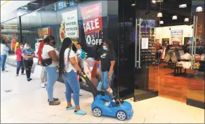  ?? Donald Eng / Hearst Connecticu­t Media ?? Customers wait outside the Eblens clothing store in Westfield Trumbull Mall on May 20.