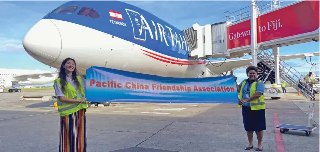  ??  ?? President of the Fiji-China Friendship Associatio­n Fangfang Jamnadas (left), helps welcome the Air Tahiti Nui flight.