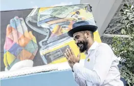  ?? MATIAS J. OCNER mocner@miamiheral­d.com ?? Brazilian artist Kobra poses in front of his mural of the late Brazilian Formula One driver Ayrton Senna during an unveiling event at the Formula One Miami Grand Prix at the Miami Internatio­nal Autodrome on Thursday in Miami Gardens.