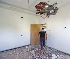  ?? AFP ?? The resident of a house hit by a rocket leaves after inspecting the damage caused in the southern suburb of Ain Zara on the outskirts of Tripoli on Tuesday.