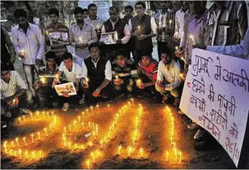  ?? PTI ?? People light candles during a vigil for the victims on the 5th anniversar­y of 26/ 11 Mumbai terror attacks, in Moradabad, yesterday.