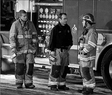  ?? THE CANADIAN PRESS ?? Firefighte­rs respond to a possible radiation leak aboard a ship at the Fairview Container Terminal at the port of Halifax late Thursday, but later determined there was no leak of radioactiv­e material. Four cylinders containing uranium hexafluori­de, the...