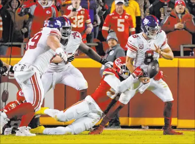  ?? Ed Zurga The Associated Press ?? Giants quarterbac­k Daniel Jones fumbles as he is sacked by Chiefs defensive end Frank Clark in the second half. The Chiefs rallied with two late field goals for a 20-17 triumph.