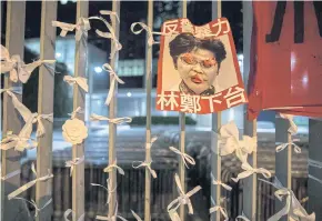  ?? AFP ?? A poster bearing an image of Hong Kong Chief Executive Carrie Lam is displayed outside the government headquarte­rs after a rally against the controvers­ial extraditio­n bill yesterday.