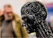  ?? Martin Meissner/Associated Press ?? A metal head made of motor parts symbolizes AI at the Essen Motor Show in Germany.