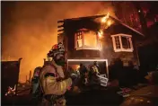  ?? ANDA CHU — BAY AREA NEWS GROUP ?? Firefighte­rs remove items from a garage after a wildland fire ignited a home along Tucker Road in Calistoga, on Friday, Oct. 2, 2020.