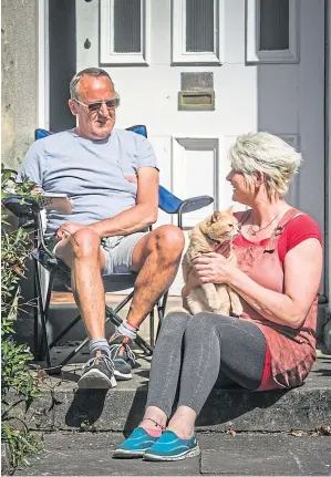  ??  ?? SUN AND GAMES: Dawn and Graham Allan at home in Newport with Zambini the cat in