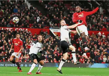  ??  ?? Rising above: Manchester United’s Romelu Lukaku heading towards the Derby goal during the English FA Cup third round match at Old Trafford on Friday. — Reuters