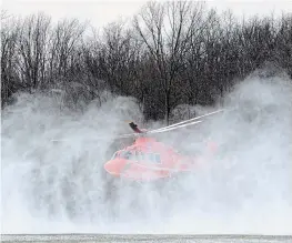  ?? DAVE JOHNSON TORSTAR ?? An Ornge air ambulance kicks up snow as it takes off from a frozen farm field off Burnaby Road in Wainfleet. A man suffered a serious injury after being struck by a tree in a woodlot Wednesday.