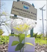  ?? MICHAEL SEARS / MSEARS@JOURNALSEN­TINEL.COM ?? Silk flowers were placed at Fritse Community Park in the Town of Menasha. The park and trestle bridge are closed as police investigat­e.