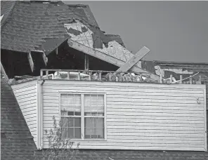  ?? JEFF FAUGHENDER/LOUISVILLE COURIER JOURNAL ?? Houses were damaged in Buckner, Ky., after severe storms hit the area on Tuesday.