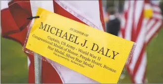  ?? Brian A. Pounds / Hearst Connecticu­t Media ?? Individual flags are dedicated in the names of veterans, including World War II Medal of Honor winner Michael J. Daly, at Jennings Park on the Post Road in Fairfield in 2017.