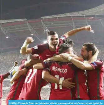  ??  ?? LISBON: Portugal’s Pepe, top, celebrates with his teammates their side’s second goal during the World Cup Group B qualifying soccer match between Portugal and Switzerlan­d in Lisbon.— AP