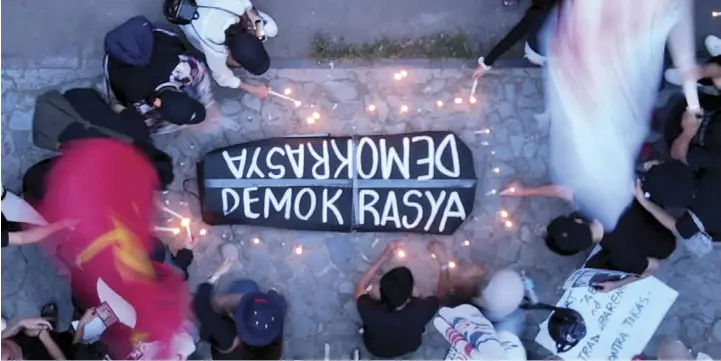  ?? JOY TORREJOS ?? Members of militant groups light candles in front of Cebu Capitol during yesterday’s 'Black Friday' protest against the incoming administra­tion of Ferdinand “Bongbong” Marcos and Sara Duterte.