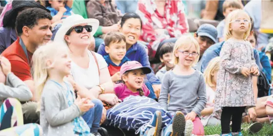  ?? ?? Above: Families watch a performanc­e during the Bay Area Book Festival. Below: Kids play with balloon swords at the festival.