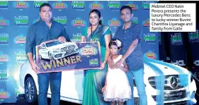  ??  ?? Mobitel CEO Nalin Perera presents the luxury Mercedes Benz to lucky winner Buvini Charithra Liyanage and family from Galle